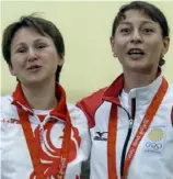  ??  ?? Russia’s Natalia Paderina, left, and Georgia’s Nino Salukvadze embrace after the 10-meter air pistol final at the Beijing Olympics in 2008.