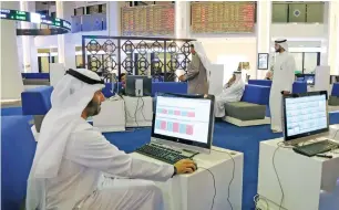  ?? — Reuters ?? Investors monitor stock activity at the Dubai Internatio­nal Financial Market.