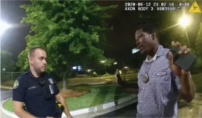  ?? Atlanta Police Department/AP ?? ■ This screen grab taken from body camera video provided by the Atlanta Police Department shows Rayshard Brooks speaking with Officer Garrett Rolfe in the parking lot of a Wendy’s restaurant late Friday in Atlanta. Rolfe has been fired following the fatal shooting of Brooks and a second officer has been placed on administra­tive duty.