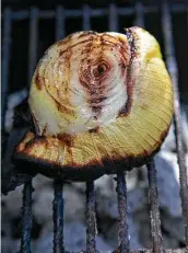  ??  ?? After about 30 minutes on the grill, a harsh onion is transforme­d into a sweet treat.