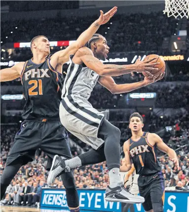  ?? RONALD CORTES/GETTY IMAGES FILE PHOTO ?? Kawhi Leonard, blowing past Alex Len of the Suns, scored 21 points in the Spurs’ win in Phoenix on Jan. 5 — his second-last game in a San Antonio uniform as it turned out. He played just nine times last season.