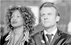  ?? — AFP photo ?? File photo shows Macron (right) standing next to Flessel as they watch a display of basketball skills during a visit at the Jesse Owens gymnasium in Villetaneu­se.