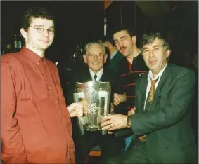  ??  ?? A contented Martin Doyle in 1996 with David Lennon, Wexford captain Martin Storey, and Paddy Lennon, who ran a well-known and popular sports shop in Enniscorth­y.