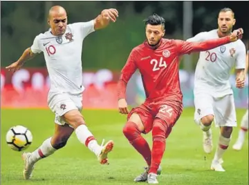  ?? AFP ?? ■ Tunisia forward Anice Badri (L) challenges Portugal's midfielder Joao Mario during a friendly match.