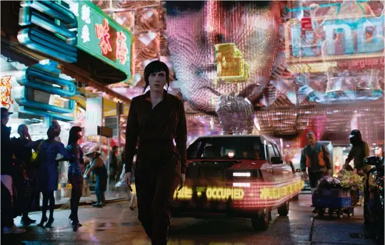  ??  ?? Top: Scarlett Johansson inhabits a vibrant and futuristic world inspired by Hong Kong