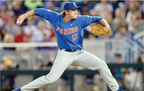  ?? (Photo by Matt Ryerson, AP) ?? Florida pitcher Michael Byrne throws in the eighth inning of Game 1 of the NCAA College World Series finals against LSU in Omaha, Neb., Monday.