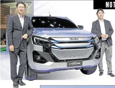  ?? ?? Isuzu Philippine­s Corp. President Leo Fujita (left) and IPC Vice President for Sales Toshihiko Kojima pose beside the Isuzu DMax EV Concept