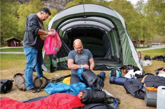  ?? Foto: Pål Christense­n, Aftenblade­t ?? ⮉ Hiwa Farok Moradi (stående) og Namo Tarin er tilbake for å rydde opp etter dramaet ved Tengesdals­vatnet.