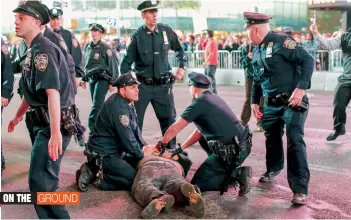  ?? — AFP ?? A man is arrested and pushed to the ground while taking part in a Solidarity Baltimore rally at TImes Square on Thursday in New York City.