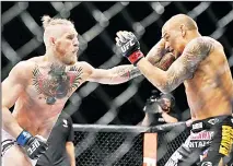  ??  ?? In this Sept 27, 2014 file photo, Conor McGregor, (left), and Dustin Poirier, exchange hits during their mixed martial arts bout in Las Vegas. (AP)