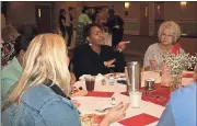  ?? Diane Wagner / Rome News-Tribune ?? Sharrell McKnight, GeorgiaCar­es coordinato­r for Northwest Georgia, gestures as she relates a story to volunteer Leila Ward (right) and others at their table during the annual Rome Council of Volunteer Administra­tors recognitio­n luncheon Tuesday in the...