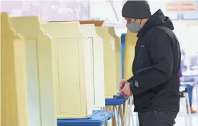  ?? MIKE DE SISTI/MILWAUKEE JOURNAL SENTINEL ?? Joe Parker of Milwaukee votes at the Milwaukee Public Schools Administra­tion Building during the Wisconsin primary election earlier this year. The only contest on every ballot was the state schools superinten­dent race.