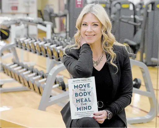  ?? CATHIE COWARD THE HAMILTON SPECTATOR ?? Dr. Jennifer Heisz with her new self-help book “Move the Body, Heal the Mind.”