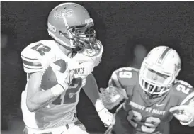  ?? [PHOTO BY NATE BILLINGS, THE OKLAHOMAN] ?? Austin Fritts (12) of OCS runs past Mount St. Mary’s Colton Cox (29) after intercepti­ng the ball during Thursday’s high school football game between Oklahoma Christian School and Mount St. Mary at Mount St. Mary Catholic High School in Oklahoma City.