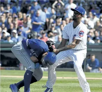  ?? DAVID BANKS/GETTY IMAGES ?? Carl Edwards Jr. of the Chicago Cubs tags out Kevin Pillar during the 11th inning on Friday at Wrigley Field in Chicago. The Cubs defeated the Jays 7-4.