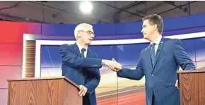  ?? MOLLY BECK / MILWAUKEE JOURNAL SENTINEL ?? State schools Superinten­dent Tony Evers (left) shakes hands with Gov. Scott Walker before their first debate.