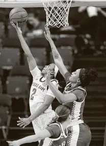  ?? Sam Craft / Associated Press ?? Texas A&M'S Aaliyah Wilson, left, shoots as Kentucky's Tatyana Wyatt defends during the first half Thursday.