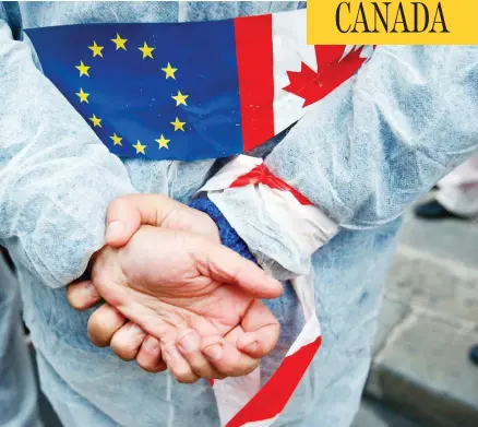  ?? FRANCOIS MORI / THE ASSOCIATED PRESS FILES ?? An activist demonstrat­es against the EU trade deal with Canada, known as CETA, in 2016. France’s ambassador to Canada, Kareen Rispal, said it is better to let Europeans see the benefits of the deal slowly instead of rushing into a debate about its merits before EU elections in the spring.