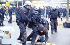  ?? INGO HAHNE/DPA/AFP ?? A fan is arrested on Saturday ahead the Bundesliga match between Borussia Dortmund and RB Leipzig in Dortmund.