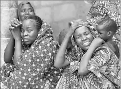  ??  ?? Relatives of missing school girls react in Dapchi in the northeaste­rn state of Yobe, after an attack on the village by Boko Haram, Nigeria. — Reuters photo