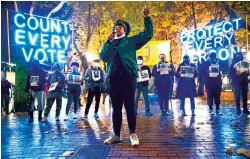  ?? ERIKA SCHULTZ/SEATTLE TIMES VIA AP ?? Travonna Thompson-Wiley, with the Black Action Coalition, speaks in November at the ‘Count Every Vote — Protect Every Person,’ rally in Occidental Park in Seattle. The coalition demanded that every vote be counted, called for an orderly transition of power and the eliminatio­n of the Electoral College.