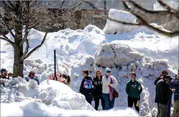  ?? WATCHARA PHOMICINDA — STAFF PHOTOGRAPH­ER ?? Residents in the San Bernardino Mountains brave long lines for food at Goodwin & Son's Market in Crestline on Friday amid a shortage caused by heavy snowfall and difficulti­es with delivery truck access on Highway 18.