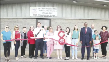  ?? Brodie Johnson • Times-Herald ?? The Littles Pediatric Clinic in Forrest City officially cut the ribbon for the business Thursday during a ceremony at the clinic. Members of the Forrest City community and community leaders gathered to congratula­te Jaci Brown, APRN, on the opening of the clinic. Brown said she already has over 400 patients and is still accepting more after being open for three months. Brown holds the scissors as the ribbon is cut.