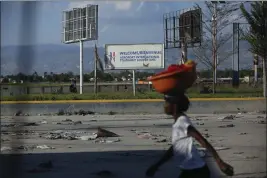  ?? ODELYN JOSEPH — THE ASSOCIATED PRESS ?? A pedestrian walks past the internatio­nal airport in Port-au-Prince, Haiti, on Monday.