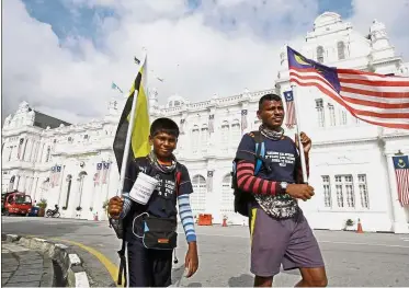  ??  ?? Penang leg: Ragu and Surya walking along the Esplanade in George Town.