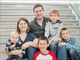  ?? Courtesy photo ?? Katie Evans with her husband and four of her six children.