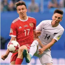  ??  ?? Russia midfielder Alexander Golovin (left) vies for the ball with New Zealand midfielder Ryan Thomas during yesterday’s 2017 Confederat­ions Cup Group A match at the Krestovsky Stadium in Saint-Petersburg. –