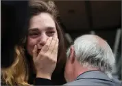  ??  ?? AP PHOTO BY MARK LENNIHAN New York Daily News staff reporter Chelsia Rose Marcius cries as she is hugged by staff photograph­er Todd Maisel after they were both laid off, Monday, July 23.