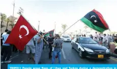  ?? — AFP ?? TRIPOLI: People wave flags of Libya and Turkey during a demonstrat­ion in Martyrs’ Square in the center of the Libyan capital on Sunday.