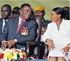  ??  ?? Crowds of excited Zimbabwean­s, far left, watched as Emmerson Mnangagwa, left with his wife Auxillia, was sworn in as the new president, bottom. The ceremony was attended by opposition politician­s as well as members of the military and judiciary, below
