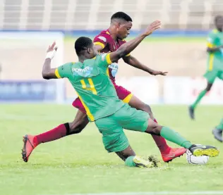  ?? PHOTO BY GLADSTONE TAYLOR ?? Jehvonne Redman of dinthill is challenged by excelsior’s Roshawn Amos in the champions cup fixture played at the National Stadium in St Andrew on Friday November 1, 2019.