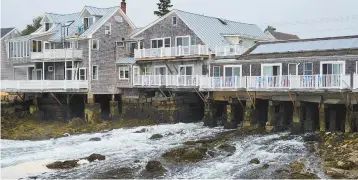  ?? ?? The Tidewater hotel is elevated above a channel of flowing tidal waters on Vinalhaven Island, Maine.