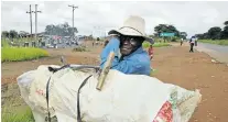  ?? Picture: BLOOMBERG ?? FOSSIL FUEL: Sanfoni Namachia, a charcoal maker, takes a break on the side of the road on the outskirts of Lusaka. Namachia is transporti­ng his charcoal to market