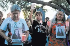  ?? Susan Montoya Bryan ?? The Associated Press Dozens of family members and friends of four women who authoritie­s say were killed by a U.S. Border Patrol agent gather Tuesday for a candleligh­t vigil at a park in downtown Laredo, Texas.