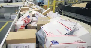  ?? [AP FILE PHOTO] ?? Packages travel on a conveyor belt for sorting Dec. 14 at the main post office in Omaha, Neb. States will be able to force shoppers to pay sales tax when they make online purchases under a Supreme Court decision Thursday that will leave shoppers with lighter wallets but is a big win for states.