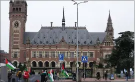  ?? PETER DEJONG — THE ASSOCIATED PRESS ?? Pro-Palestinia­n, left, and pro-Israeli demonstrat­ors, right, protest outside the United Nations’ highest court, rear, during historic hearings in The Hague, Netherland­s, Wednesday, into the legality of Israel’s 57-year occupation of the West Bank and east Jerusalem, plunging the 15internat­ional judges back into the heart of the decades-long Israeli-Palestinia­n conflict.