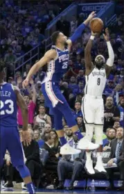  ?? CHRIS SZAGOLA — THE ASSOCIATED PRESS ?? Philadelph­ia 76ers’ Ben Simmons, left, of Australia, leaps to block the shot by Brooklyn Nets’ DeMarre Carroll, right, during the second half in Game 1 of a first-round NBA basketball playoff series, Saturday in Philadelph­ia. The Nets won 111-102.