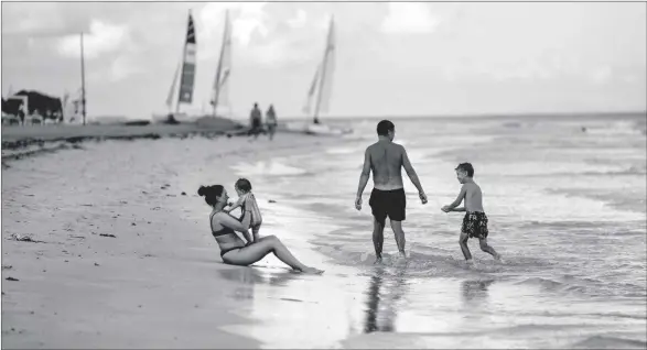  ?? AP PHOTO/RAMON ESPINOSA ?? Tourists are seen along the beach at the Iberostar Selection Varadero hotel in Varadero, Cuba, in 2021.