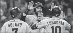  ?? Hayne Palmour IV / San Diego Union-tribune /TNS ?? The San Francisco Giants' Brandon Belt (middle) and Donovan Solano (7) celebrate a three-run home run by Evan Longoria (10) in the fifth inning against the San Diego Padres at Petco Park in San Diego ontuesday, July 2, 2019