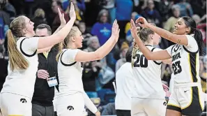  ?? HANS PENNINK THE ASSOCIATED PRESS ?? Iowa players celebrate their win over Colorado in a Sweet 16 game at the NCAA Tournament.