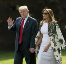  ?? J. SCOTT APPLEWHITE — THE ASSOCIATED PRESS ?? Without taking questions from reporters about the Mueller report, President Donald Trump and first lady Melania Trump walk to board Marine One for the short trip to Joint Base Andrews, then on to his estate in Palm Beach, Fla., at the White House in Washington, Thursday.