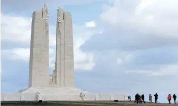  ?? PHILLIPPE HUGUEN/GETTY IMAGES ?? Visitors look at the Canadian National Vimy Memorial in Vimy, France. The monument is inscribed with the names of 11,285 Canadian soldiers who were killed in France during the First World War and whose final resting place was unknown.