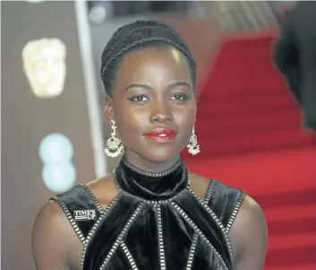  ?? JOEL C RYAN/ INVISION ?? Actress Lupita Nyong’o poses for photograph­ers upon arrival at the BAFTA 2018 Awards in London on Sunday. From black dresses and Time’s Up pins, to impassione­d speeches and white roses — this awards season has been filled with women’s empowermen­t...