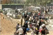  ?? PHOTO: REUTERS ?? People gather before being evacuated from the besieged Damascus suburb of Daraya.