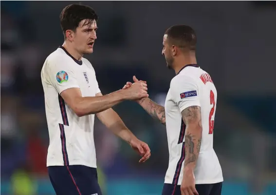  ??  ?? England's Harry Maguire, left, congratula­tes England's Kyle Walker at the end of the Euro 2020 soccer championsh­ip quarterfin­al soccer match between Ukraine and England at the Olympic stadium, in Rome, Italy