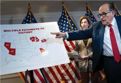  ?? Photograph: Drew Angerer/Getty Images ?? Rudy Giuliani points to a map as he speaks to the press about various lawsuits aimed at overturnin­g the 2020 election. Also pictured is Trump attorney Sidney Powell.